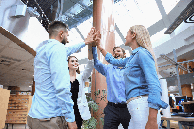 a group of people giving each other a high five